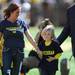Oklahoma resident Sharon Barton walks with her five-year-old son Cooper after being taken on the field during a time out in the first quarter at Michigan Stadium on Saturday. Cooper made national headlines when his teachers asked him to turn his Michigan t-shirt inside out while at school. Melanie Maxwell I AnnArbor.com